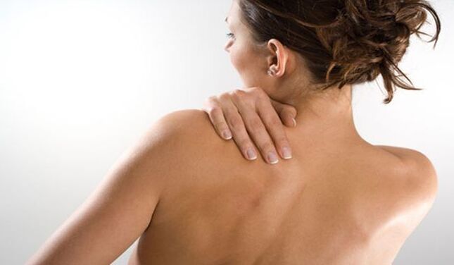 A woman is worried about pain in the back under the left shoulder blade